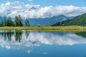 Freshwater Prints: View of reflection of mountains and clouds in Plettsaukopf Reservoir on a sunny day