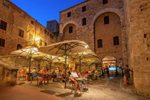 Eateries Prints: View of restaurant in historic centre at dusk