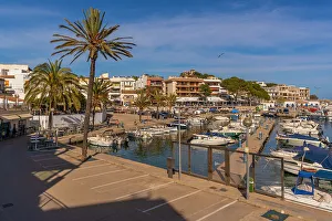 Sailboats Prints: View of restaurants in the harbour at Cala Rajada