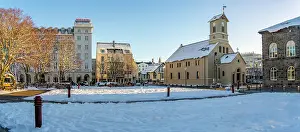 Wonderland Prints: View of Reykjavik Cathedral from Austurvollur park and gardens on a sunny day in winter