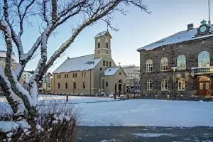 Wonderland Prints: View of Reykjavik Cathedral from Austurvollur park and gardens on a sunny day in winter