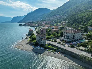 Roads Prints: View of Rezzonico on Lake Como with buildings, beach, and mountains in background