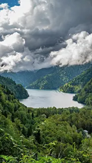 Lush Prints: View of Ritsa Lake surrounded by mountains and clouds in Ritsa Relict National Park