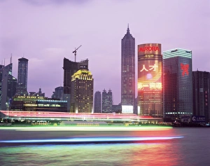 View across river at dusk to the new Pudong district skyline, Huangpu River