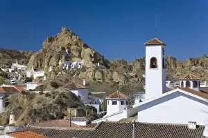 View across rooftops to cave houses in the troglodyte district, Guadix