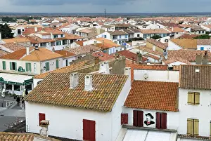 Tiles Prints: View of rooftops in Saintes-Maries-de-la-Mer showing traditional architecture and the landscape beyond in France