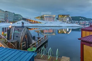Ferris Wheel Prints: View of saunas, Oslo Opera House and Munch Museum reflecting in harbour on cloudy evening