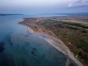 Wetlands Prints: View of Sigeion cape in Cannakale, Turkey at sunset showcasing the land and sea