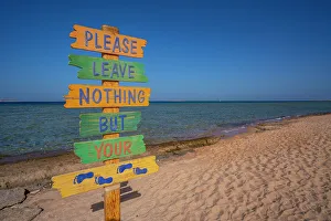 Sahl Hasheesh Prints: View of sign reading Please Leave Nothing But Your Footprints on the Beach