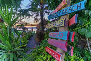 Thassos Town Prints: View of signpost on beach after sunset