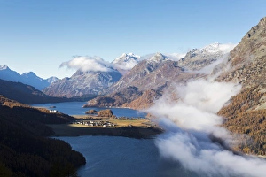 Sils Prints: View of Sils and the blue lake surrounded by mist in autumn, Surlej, St