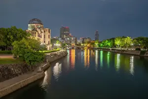 Solemn Prints: View of the skeletal ruins of the A-Bomb Dome from Hiroshima Peace Gardens at dusk