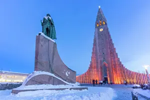 Locals Prints: View of Skolavorduholt statue and Hallgrimskirkja church at dusk in winter