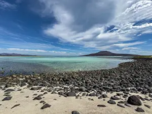 White Clouds Prints: A view of the small bay and the extinct volcano on the south side of Isla Coronado