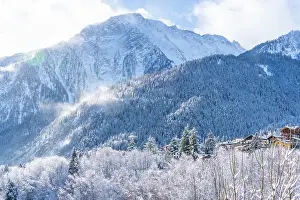 Chill Prints: View of snow covered chalets, trees and mountains from Dolonne in winter