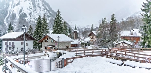 Aosta Prints: View of snow covered houses and church in Entreves in winter