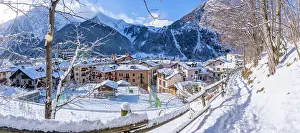 Courmayeur Prints: View of snow covered mountains and rooftops in Courmayeur in winter