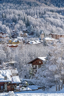 Courmayeur Prints: View of snow covered trees and Courmayeur from Dolonne in winter