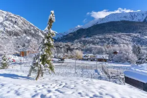 Skiing Prints: View of snow covered trees, mountains and Courmayeur from Dolonne in winter