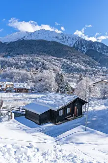 Covered Prints: View of snow covered trees, mountains and Courmayeur from Dolonne in winter