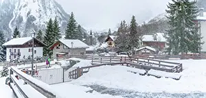 Chalet Prints: View of snow covered wooden houses and church in Entreves in winter