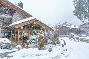 Aosta Prints: View of snow covered wooden houses in Entreves in winter