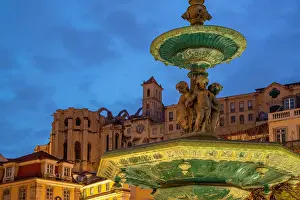 Enchanting Prints: View of South fountain of Rossio in Praca do Rossio and Carmo Archaeological Museum at dusk