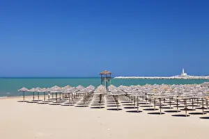 Order Prints: View over Spiaggia di San Lorenzo beach to the lighthouse on Isola di Sant Eufemia Island