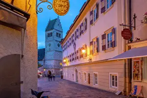 Stroll Prints: View of St. Hippolyte Church and Stadtplatz at dusk with lights glowing in Zell am See