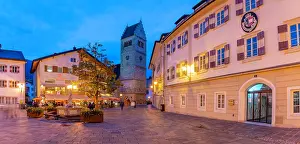 Nightlife Prints: View of St. Hippolyte Church and Stadtplatz in Zell am See during dusk with lights shining on buildings