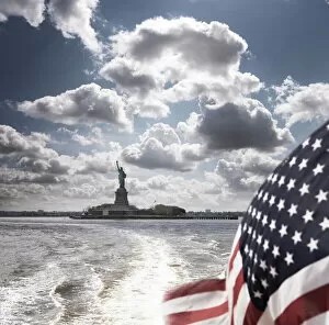 Images Dated 15th June 2010: View of Statue of Liberty from rear of bot with Stars and Stripes flag