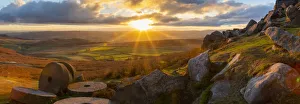 View of sunset and old millstones at Curbar Edge during autumn, Derbyshire, Peak