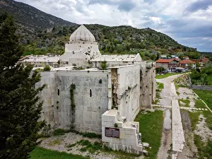 Settlement Prints: View of Susuz Caravanserai showing medieval architecture in Turkey's countryside with surrounding nature