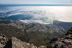 Urban Sprawl Prints: The view from Table Mountain over Camps Bay covered in low cloud, Cape Town, South Africa
