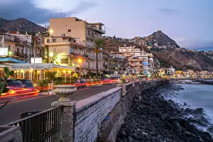 View of Taormina and Giardini Naxos promenade viewed from Giardini Naxos at dusk, Sicily, Mediterranean, Italy, Europe