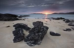 Images Dated 1st January 1970: View towards Taransay at sunset from the rocky shore at Scarista, Isle of Harris