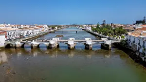 Algarve Prints: View of Tavira with its historic bridge and river in Portugal's Algarve region during a sunny day