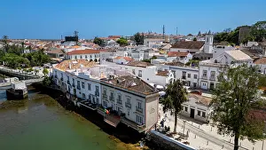 Streets Prints: View of Tavira Portugal showcasing historic buildings and waterways on a clear day with vibrant community life