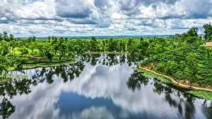 Gardening Prints: View of the tea gardens and water bodies in Sreemangal tea region of Bangladesh with cloudy skies above