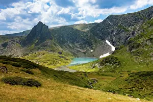 Mountainous Prints: View of Tear Lake surrounded by rocky peaks and grassy slopes in the Seven Rila Lakes area near Sapareva Banya