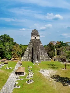 Pyramid Prints: View of Temple I at Tikal surrounded by ancient structures and greenery in Guatemala