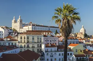 View of terracotta roofs and the ancient castle and dome from Miradouro Alfama viewpoint