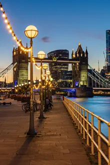 View of Tower Bridge and City of London at sunset, from Shad Thames, London, England