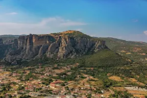 Thessaly Prints: View of a town under rocky cliffs with hills and trees in Thessaly Greece
