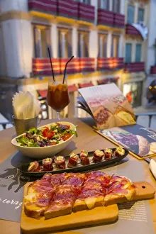 Choice Prints: View of traditional Spanish tapas overlooking Plaza del Siglo at dusk