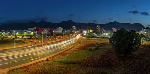 Light Trail Prints: View of trail lights and city skyline in Port Louis at dusk