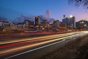 Light Trail Prints: View of trail lights and city skyline in Port Louis at dusk