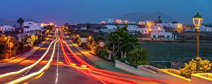 Light Trail Prints: View of trail lights through the town of Tinajo at dusk
