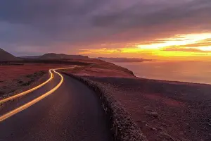 Light Trail Prints: View of trail lights and volcanic coastline from Mirador del Rio at sunset