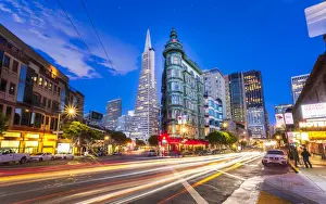 View of Transamerica Pyramid building on Columbus Avenue and car trail lights, San Francisco